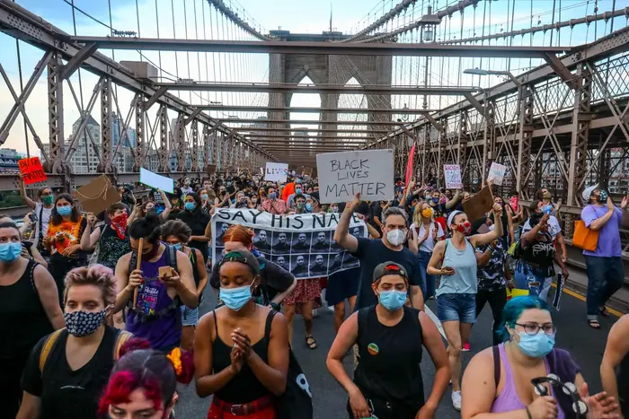 Protesters march over the Brooklyn Bridge during a Juneteeth March on June 20, 2020.